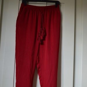 Red relaxed pants with tassels